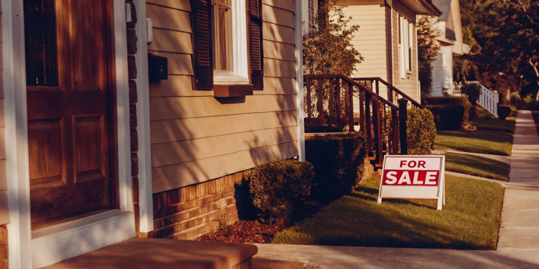 For Sale sign in front of a house.