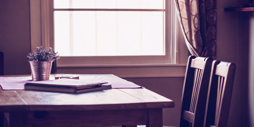 Buyer and seller reviewing closing costs documents at table.