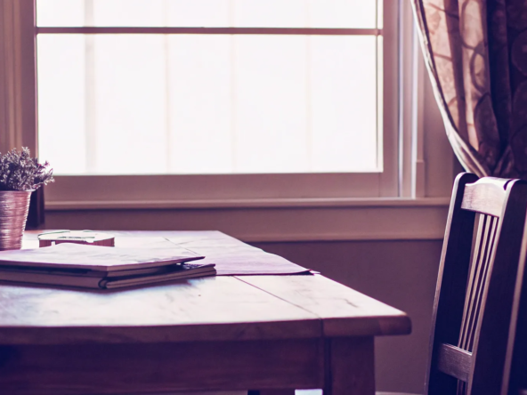Buyer and seller reviewing closing costs documents at table.