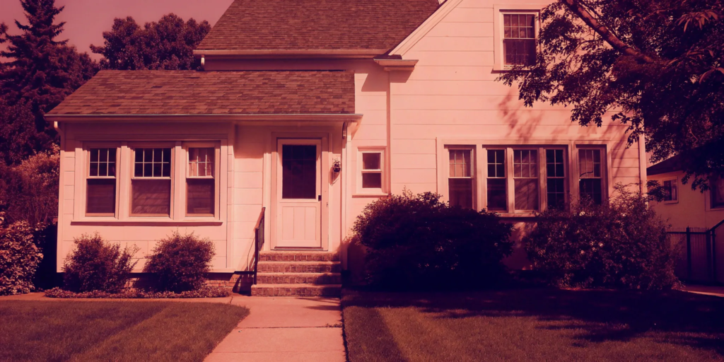 A white house with a green lawn being sold through the probate process.