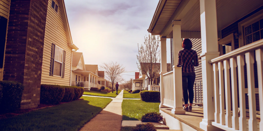 Homeowner on their front porch preparing to sell their home without a realtor.