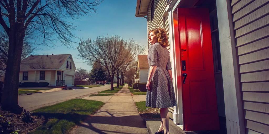 Woman outside her home learning to sell a house if you are behind on payments.