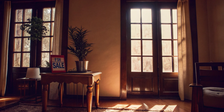 A bright living room with a for sale sign, part of the checklist for selling a house without a realtor.