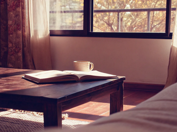 Open book on a living room table, outlining a homeowner's responsibility after a foreclosure.