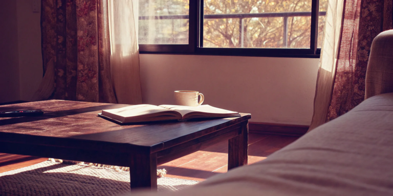 Open book on a living room table, outlining a homeowner's responsibility after a foreclosure.
