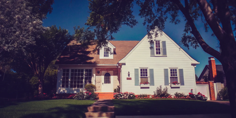 A white house with blue shutters for a buyer who will buy my house as is.