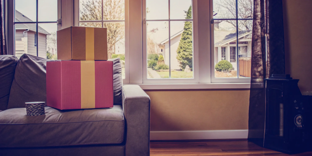 Moving boxes packed on a couch, the result of an easy decision to sell my house for cash online.