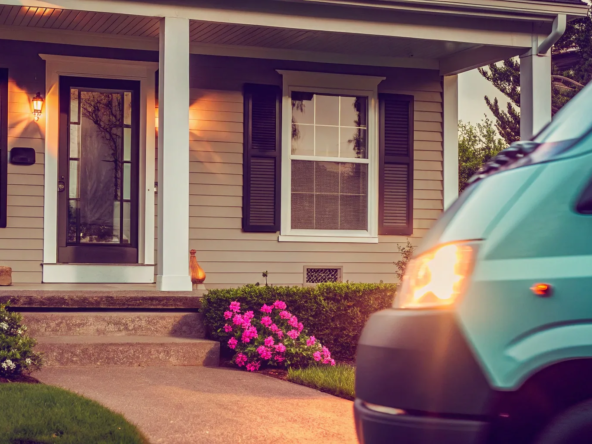 A quick sale house buyer's van parked in the driveway of a suburban home.