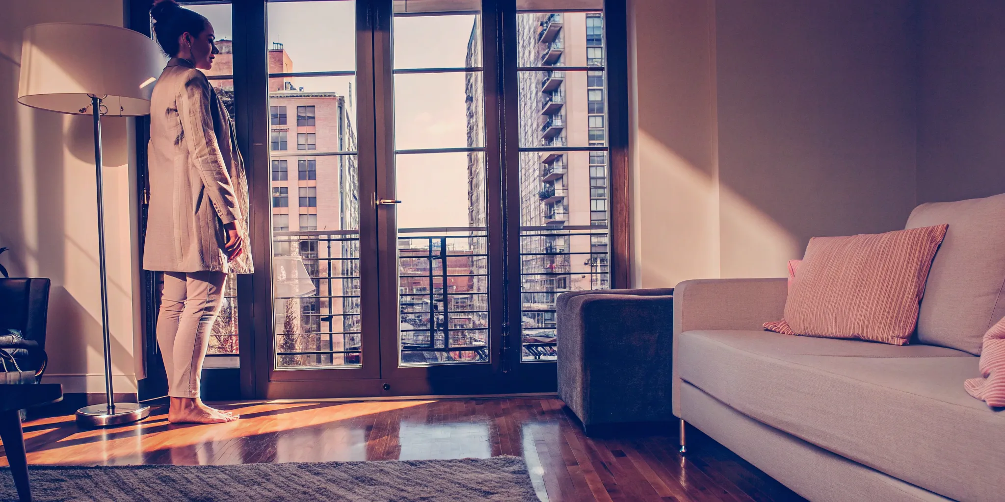 Woman in a modern condo considering the process to sell my condo for cash.