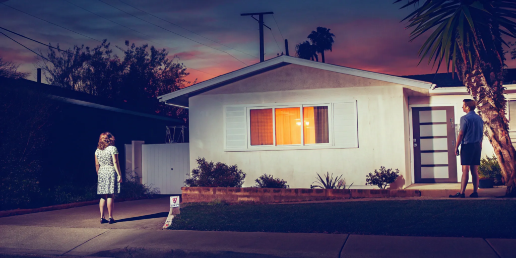 Couple in front of their home weighing the pros and cons of a short sale vs foreclosure.