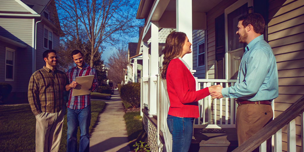 A home seller shakes hands with a buyer from a company that pays all closing costs.