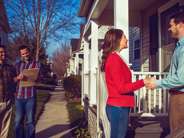 A home seller shakes hands with a buyer from a company that pays all closing costs.