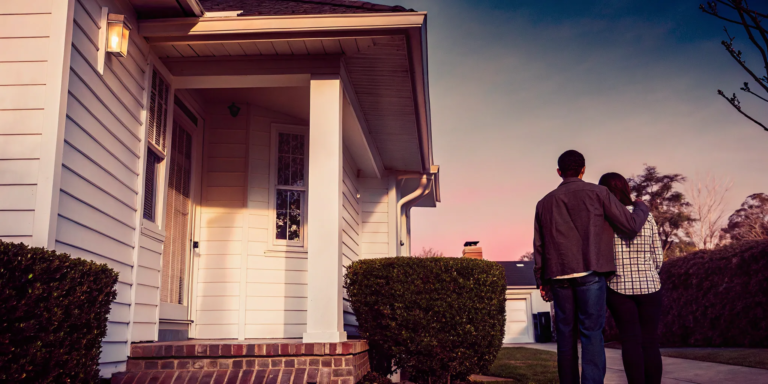 Couple standing outside their home, planning how to get a cash offer.