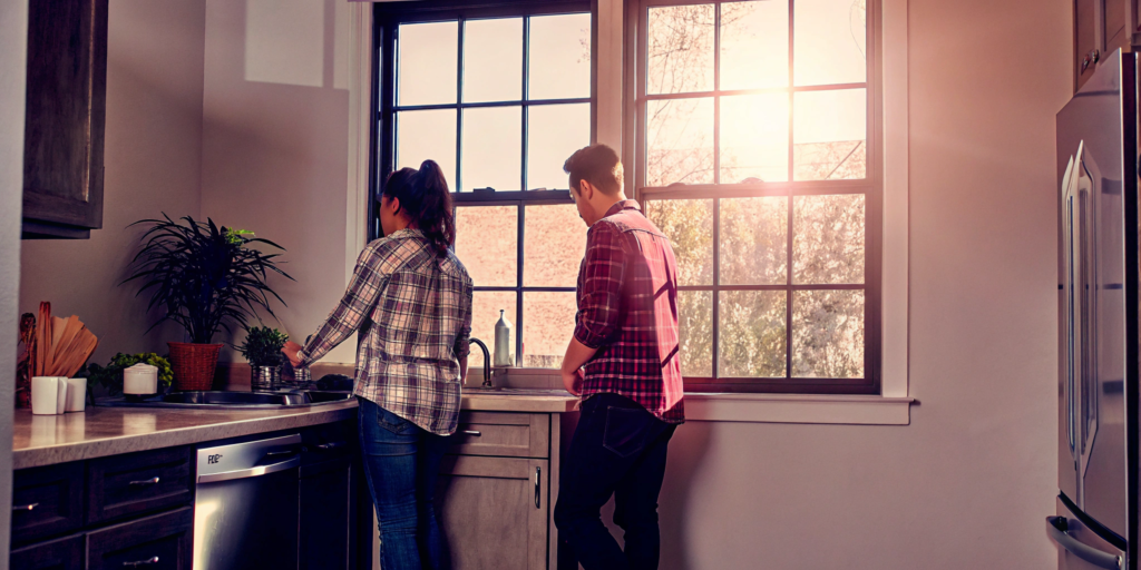 Couple in a kitchen planning to sell a house in as-is condition.