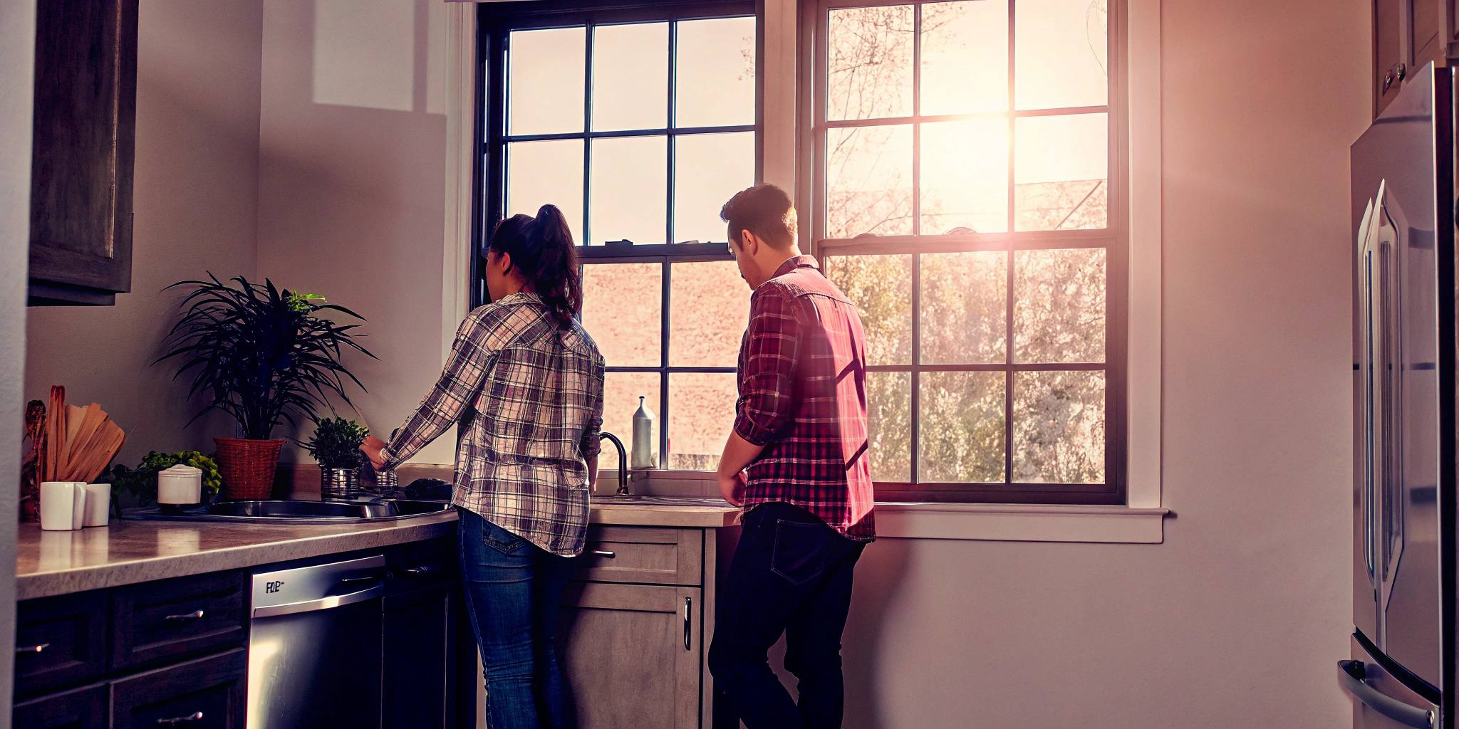 Couple in a kitchen planning to sell a house in as-is condition.