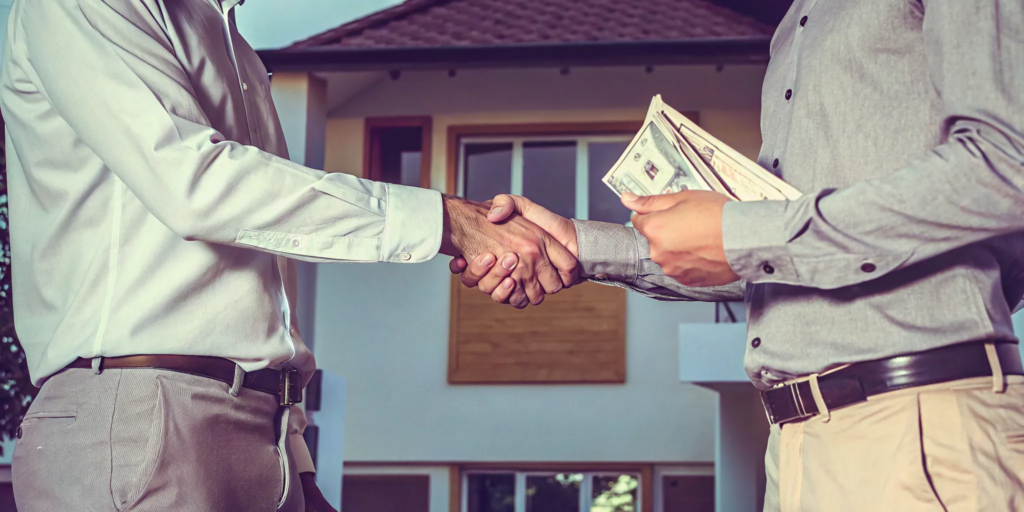 A homeowner accepts a cash offer for their house in Cicero by shaking hands with the buyer.