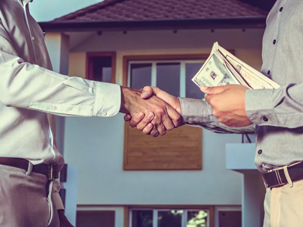 A homeowner accepts a cash offer for their house in Cicero by shaking hands with the buyer.