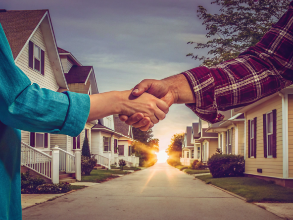 A homeowner and a legit cash home buyer shake hands, finalizing a trustworthy home sale.