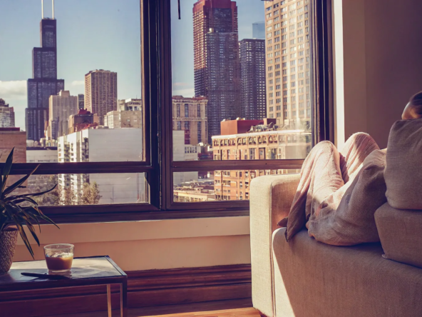 A woman relaxes in her Chicago condo, ready to sell her property for cash.