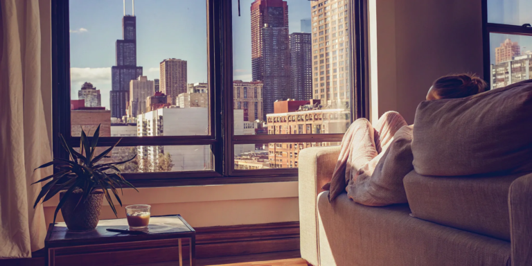 A woman relaxes in her Chicago condo, ready to sell her property for cash.