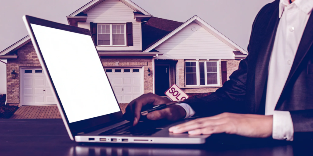 A homeowner uses a laptop to sell their house for cash online instantly.