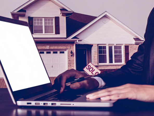 A homeowner uses a laptop to sell their house for cash online instantly.