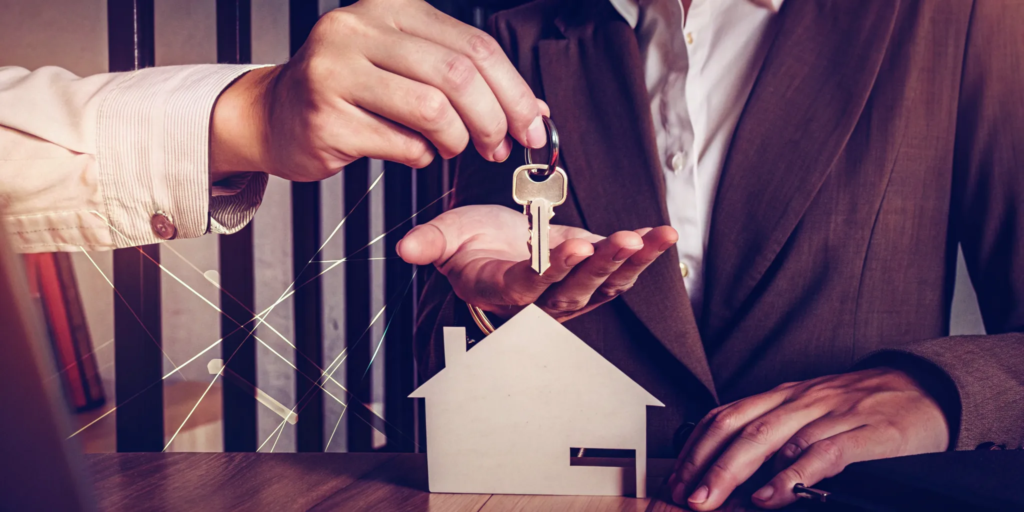 A homeowner hands over keys, a final step in the guide to sell my house fast.