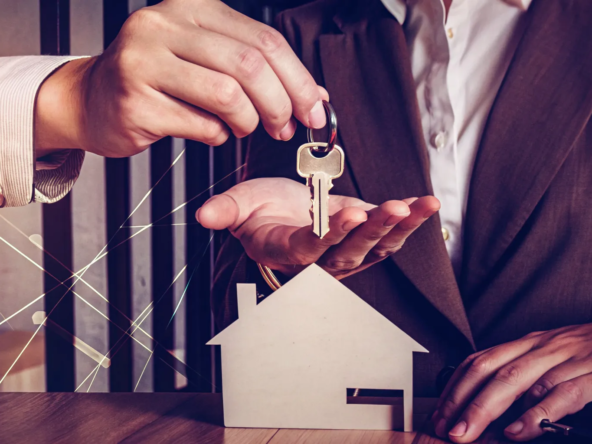 A homeowner hands over keys, a final step in the guide to sell my house fast.